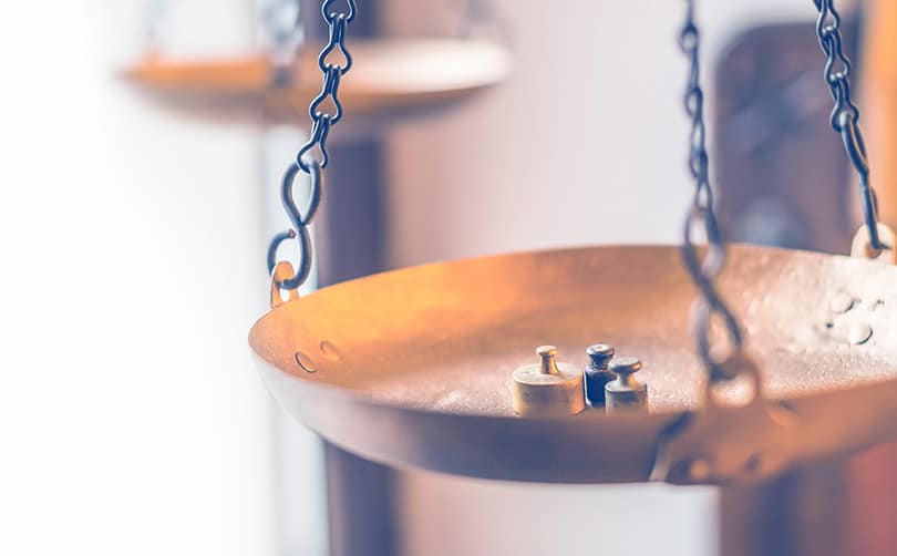 small weights on a large brass scale